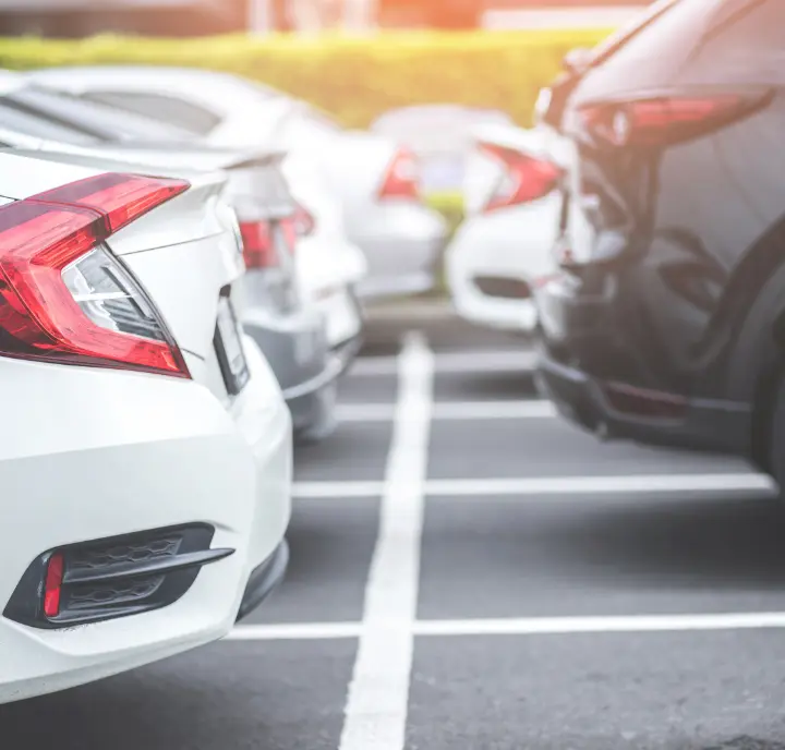 A row of cars parked in a parking lot