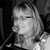 A woman singing into a microphone A woman singing into a microphone