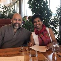 A man and woman smiling at a table in a restaurant