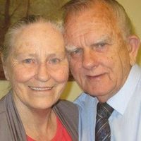 An older man and woman posing for a photo