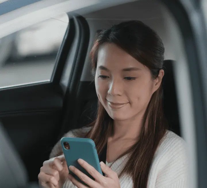 A woman in a car looking at her phone A woman in a car looking at her phone
