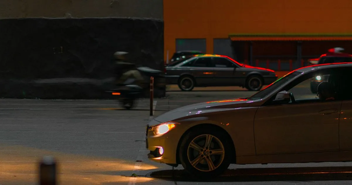 Cars parked in a busy city street with tall buildings in the background