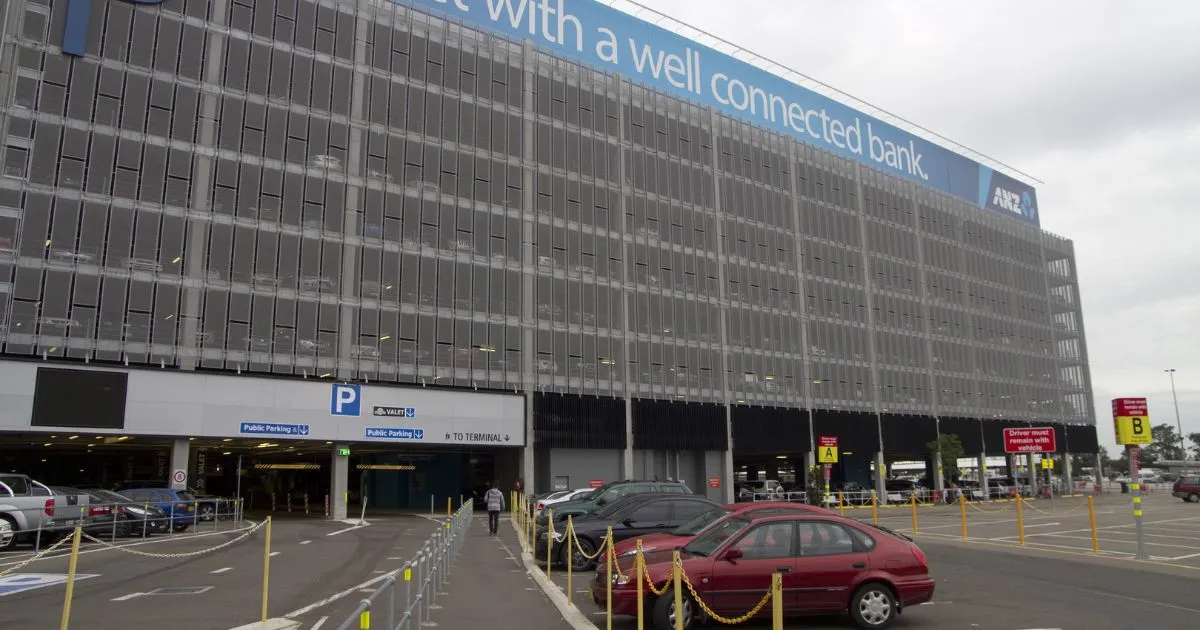 Cars parked in front of a big commercial building in Mascot