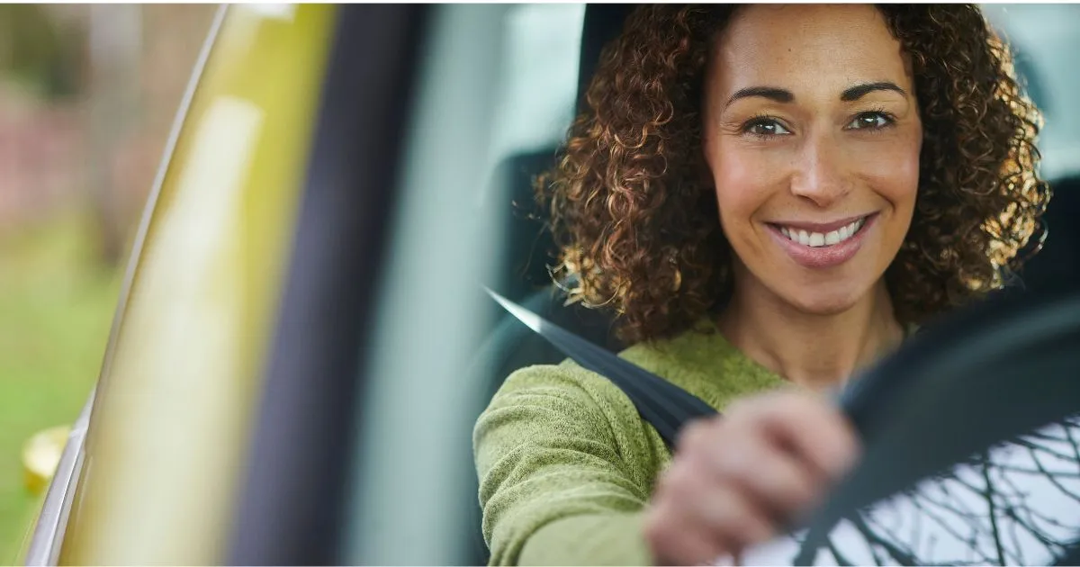 A Female Driver Taking Her Car Out Of A Parking Lot With A Smiling Face A Female Driver Taking Her Car Out Of A Parking Lot With A Smiling Face