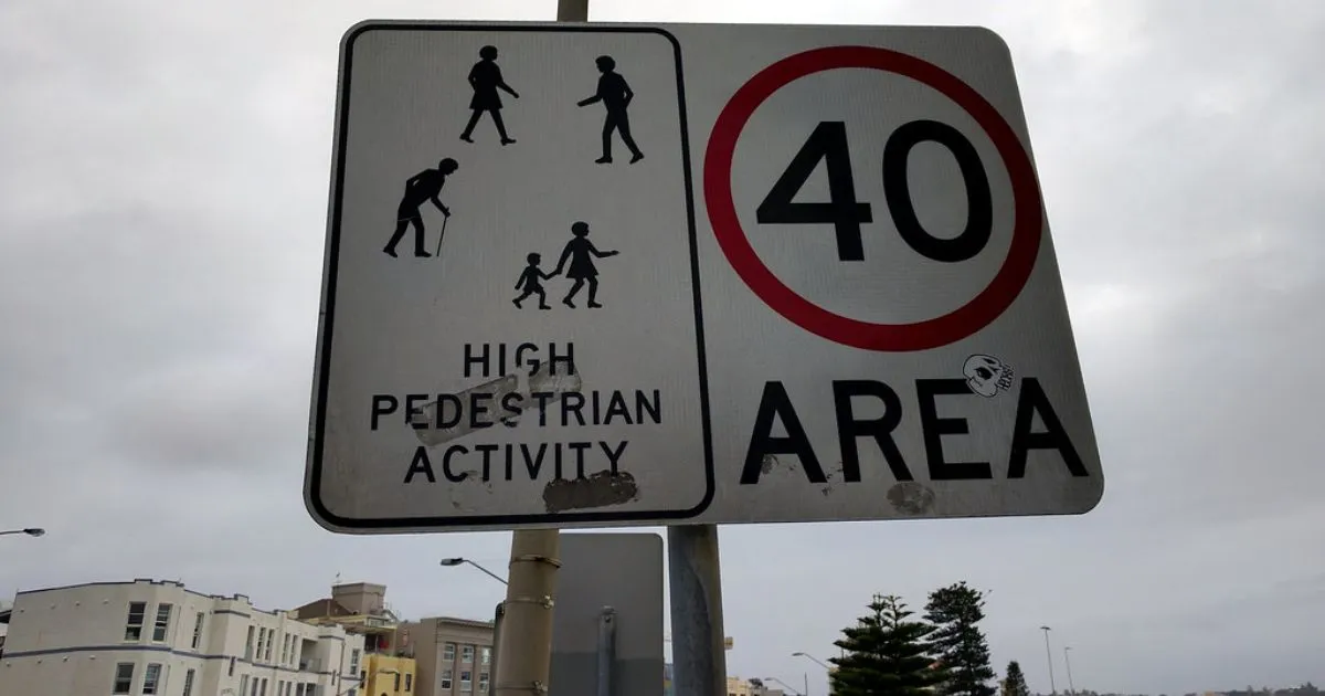 A High Pedestrian Activity Sign Displayed On The Road Leading To Bondi Beach