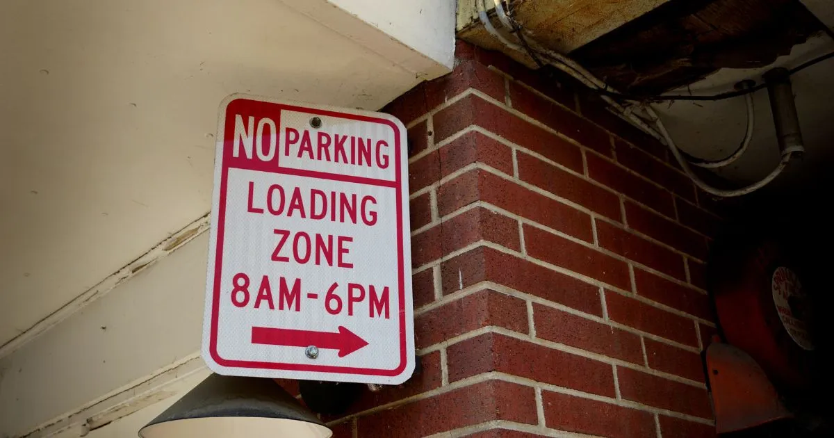 A Loading Zone Sign With Time Instructions For Drivers A Loading Zone Sign With Time Instructions For Drivers