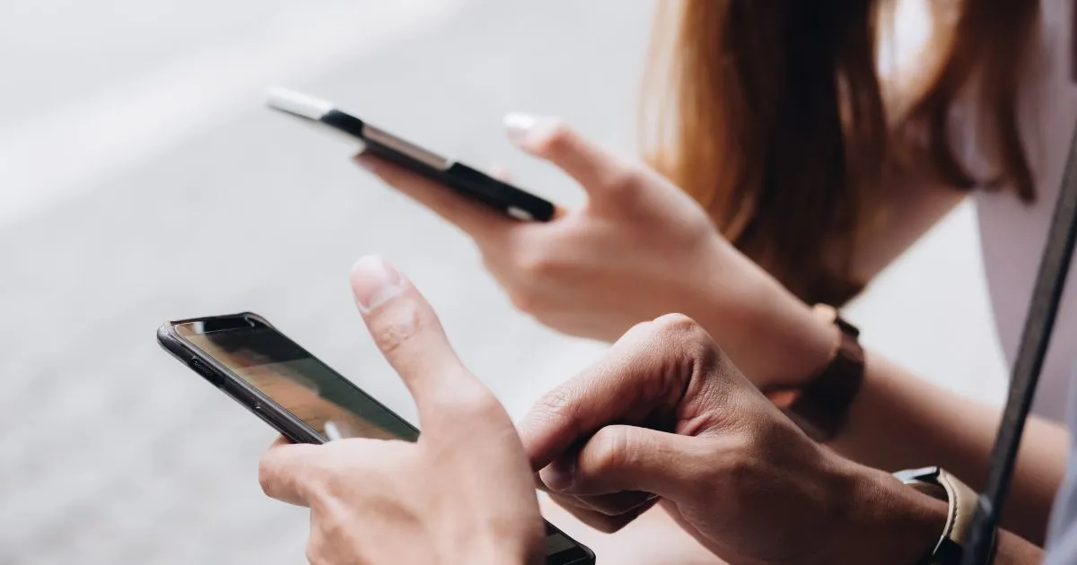 A Male And Female Using Their Phone To Find And Book Parking For Their Vehicles A Male And Female Using Their Phone To Find And Book Parking For Their Vehicles