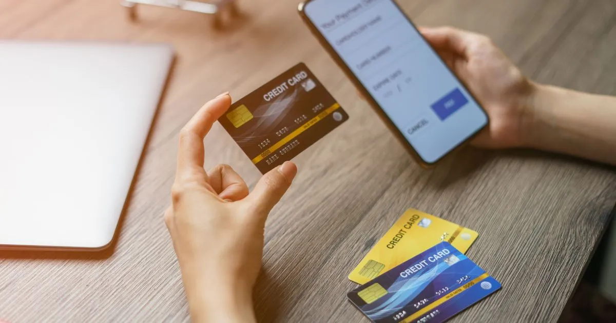 A Man Paying Parking Fine Via His Phone Using A Credit Card