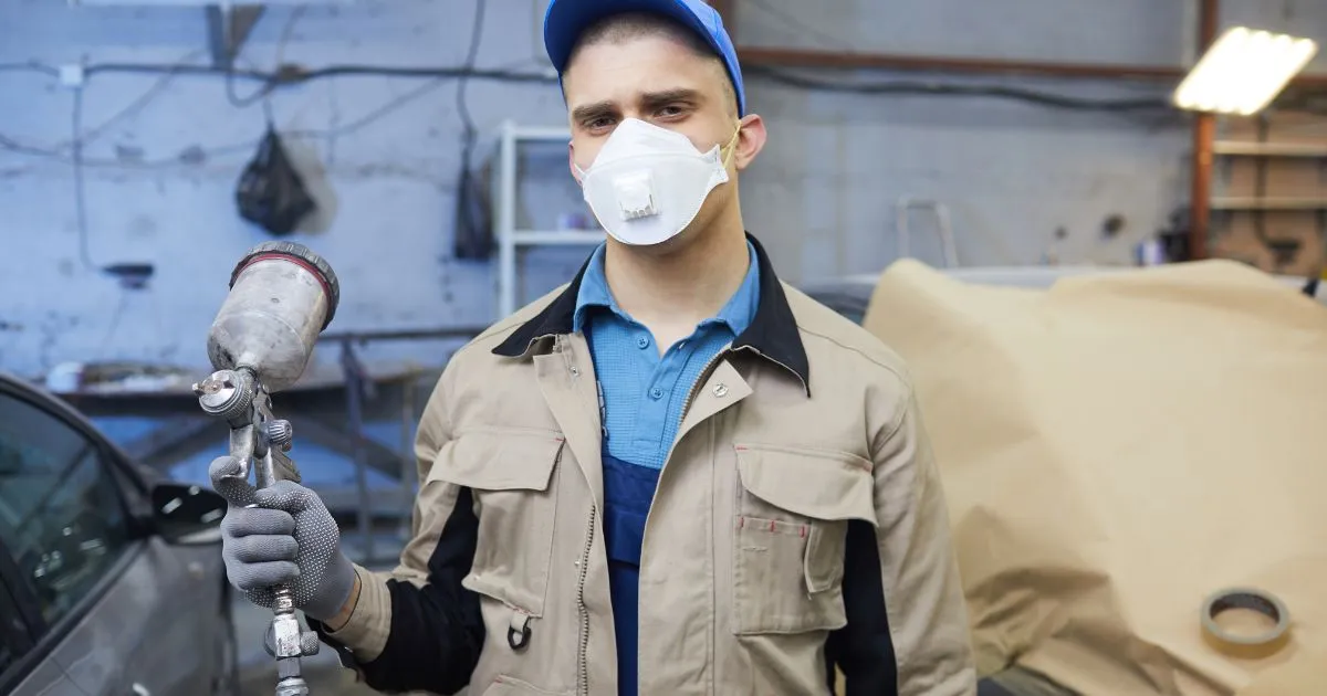 A Professional Car Painter With The Painting Equipment A Professional Car Painter With The Painting Equipment