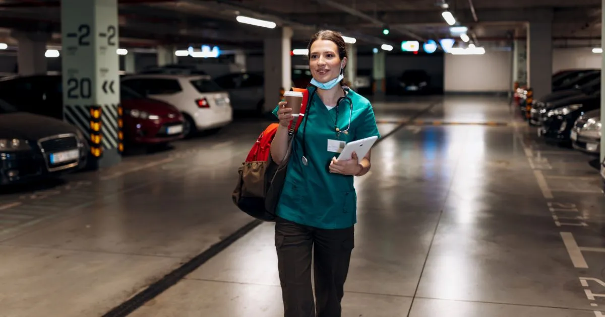 A Satisfied Female Driver In A Parking Garage After Parking Her Vehicle