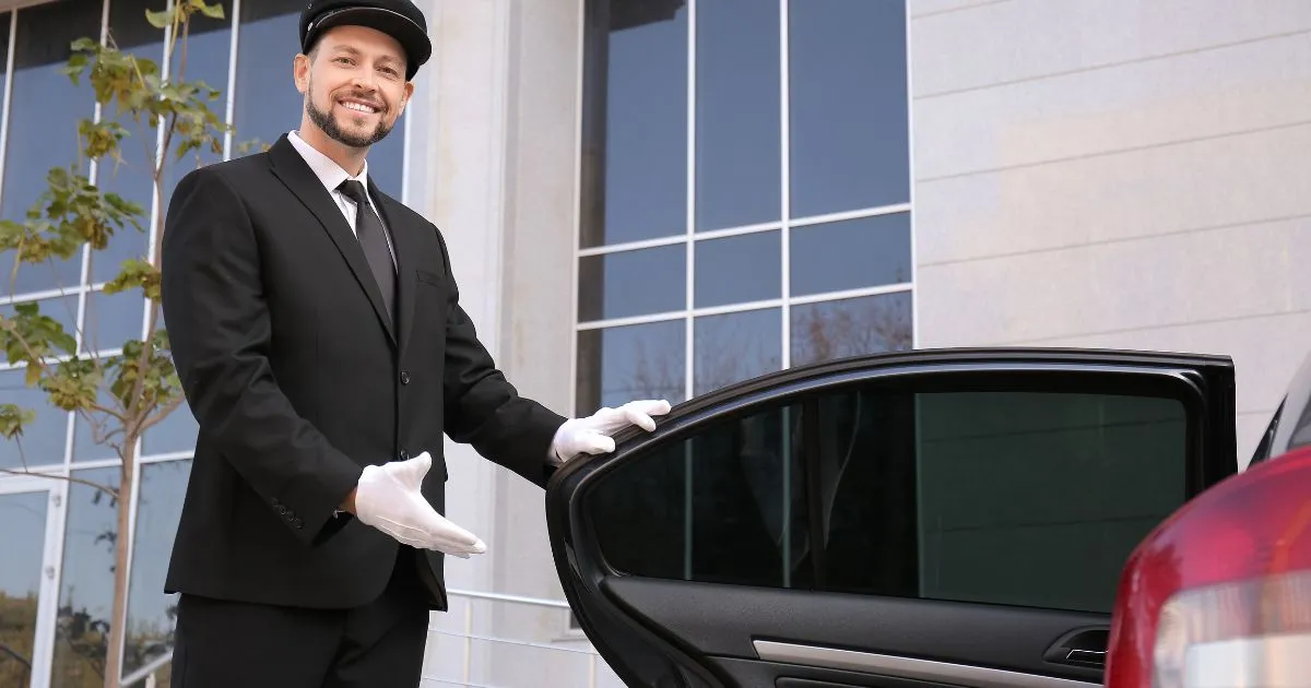 A Valet Attendant Says Good Bye To A Departing Guest A Valet Attendant Says Good Bye To A Departing Guest