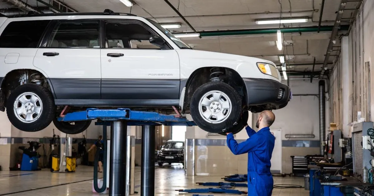A Vehicle Getting Inspected By An Expert In A Workshop A Vehicle Getting Inspected By An Expert In A Workshop