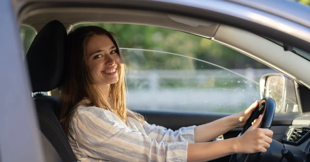 A Woman Giving A Smile After Parking Her Car Perfectly
