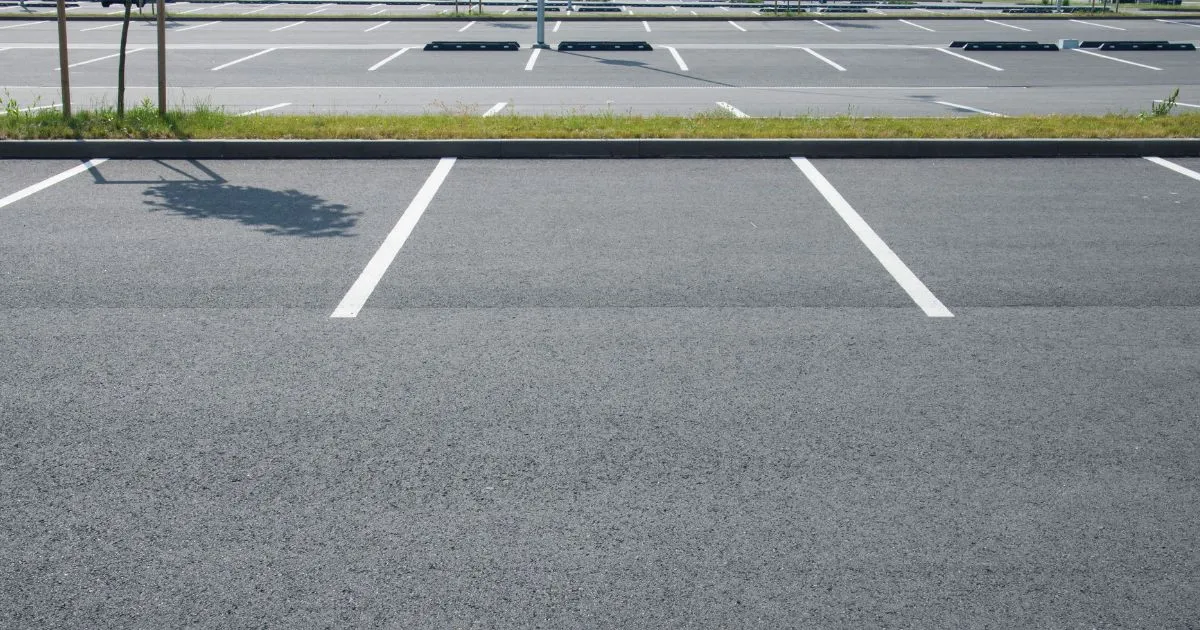 An Empty Open Parking Lot With Numerous Available Parking Spaces An Empty Open Parking Lot With Numerous Available Parking Spaces