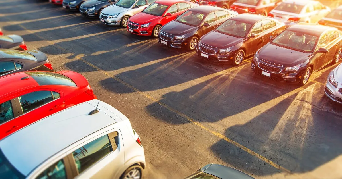Cars Parked Outdoors In The Sun In Tandem In A Parking Lot