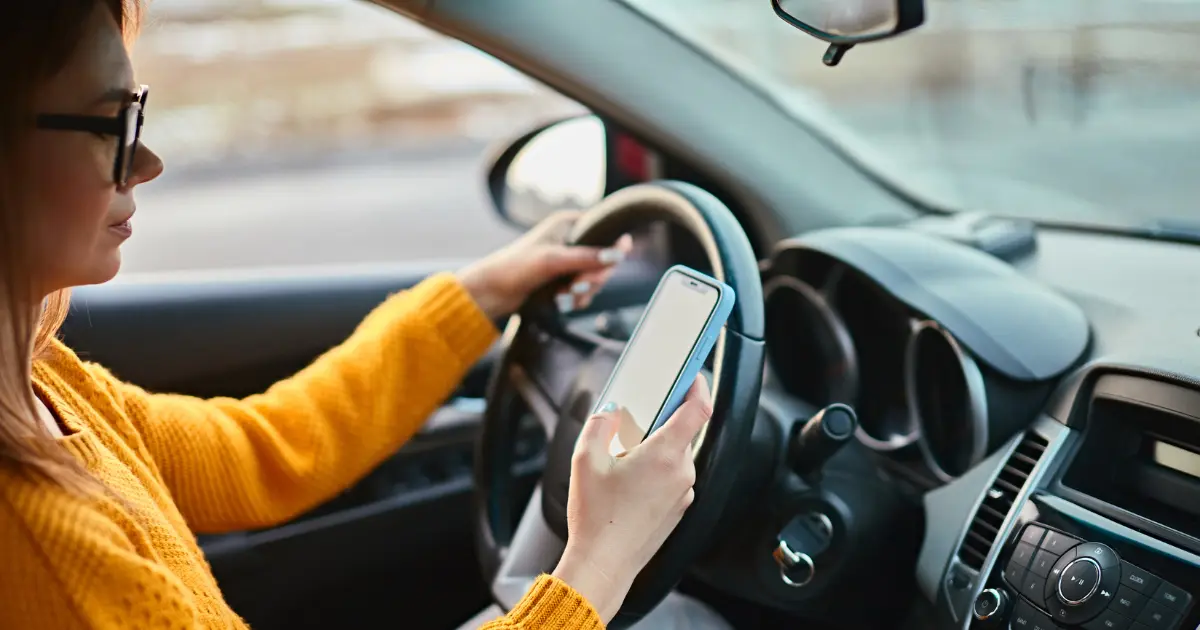 Female Driver Using Mobile To Find Parking Via An App