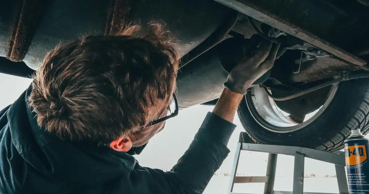 Man Fixing Vehicle Engine In Parking Space Man Fixing Vehicle Engine In Parking Space