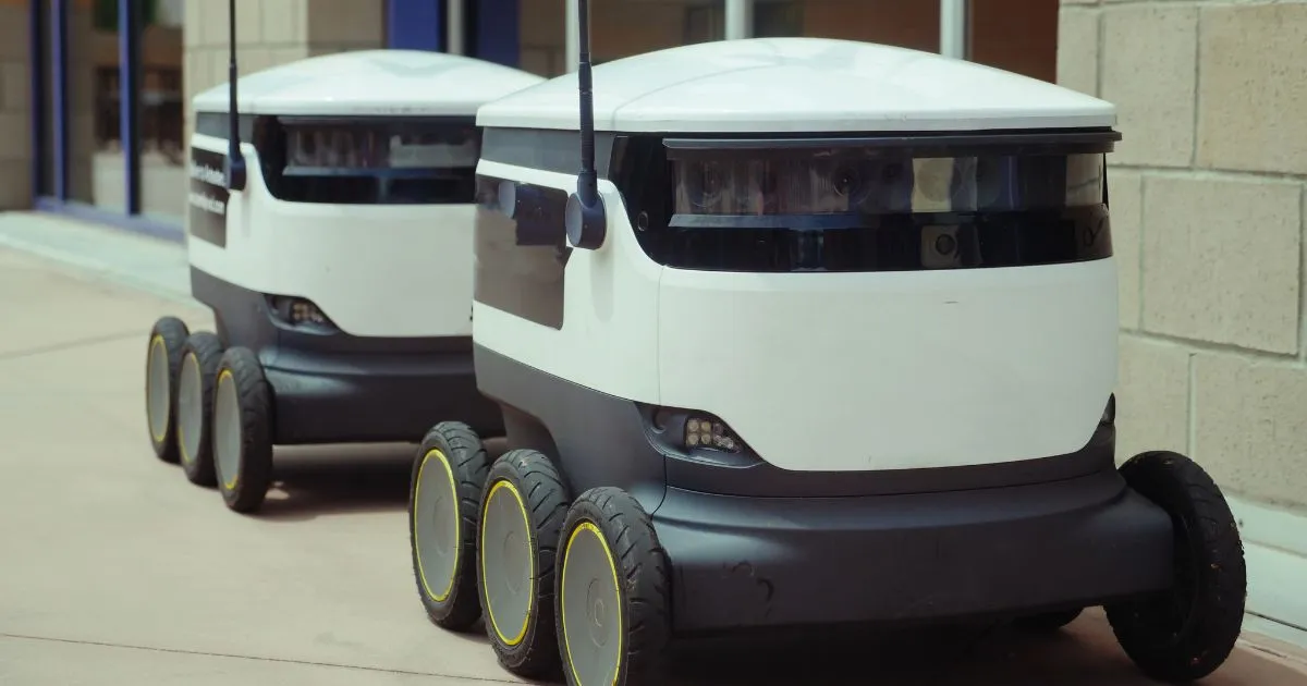 Two Autonomous Vehicles Parked Outside A Building